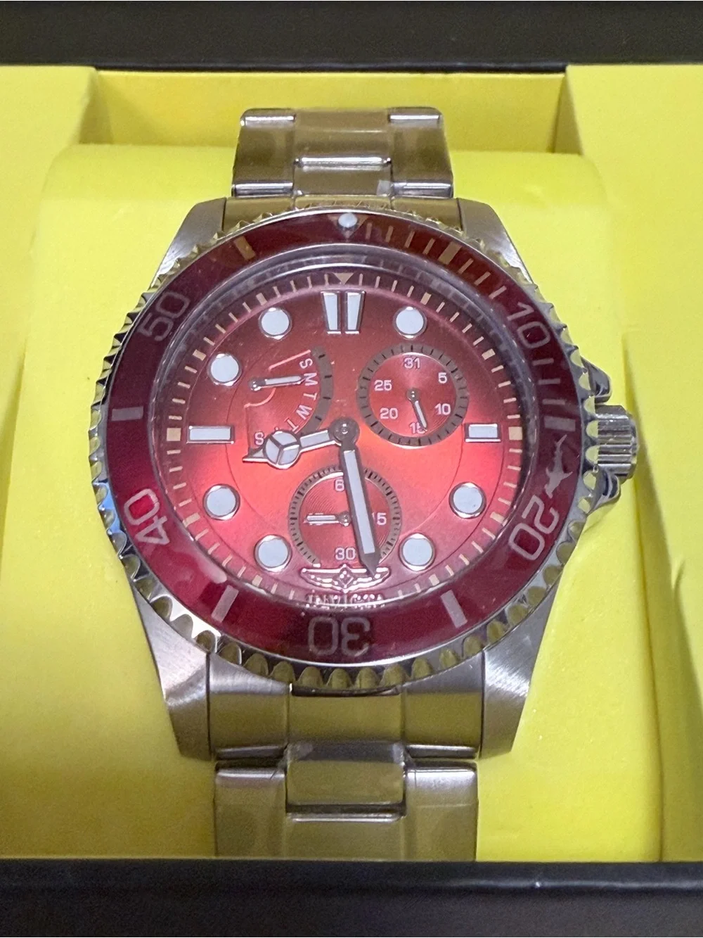 Invicta Pro Diver series stainless steel watch featuring a striking red dial